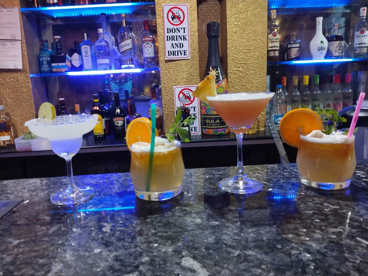 Guest enjoying cocktails at Octima Restaurant, Bar & Cafe